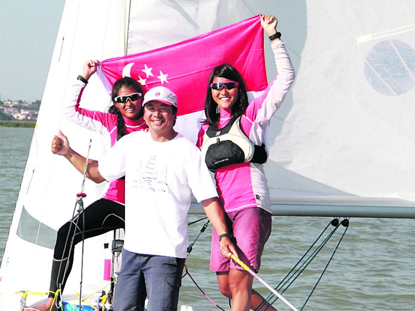 Rachel Lee (right) and Cecilia Low, with their coach Zhang Yongqiang in 2012. Photo: Singapore Sailing Federation