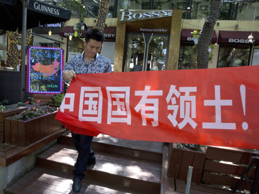 A restaurant's banner partly reads "South China Sea is China's territory"  in Beijing on Wednesday, July 13, 2016. Photo: AP