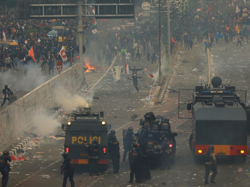 Riot police fire tear gas during university students' protest outside the Indonesian Parliament in Jakarta on Sept 24.