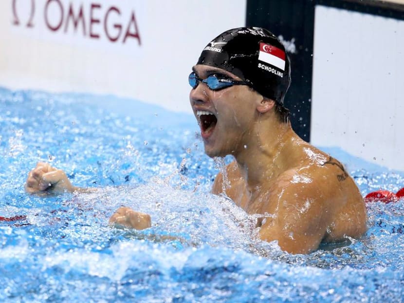 Joseph Schooling takes historic gold medal in Olympic record time of 50.39secs. PHOTO: Reuters