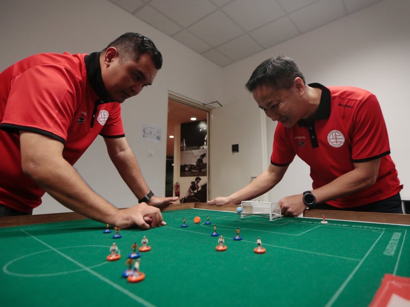 Singapore's top-ranked table football player Rudy Hesty (left) taking on Table Football Association of Singapore president Tan Kok Wee in a game of Subbuteo. Photo: Jason Quah/TODAY