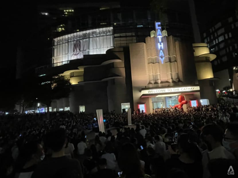 Large crowds outside The Cathay as people gather to watch busker perform