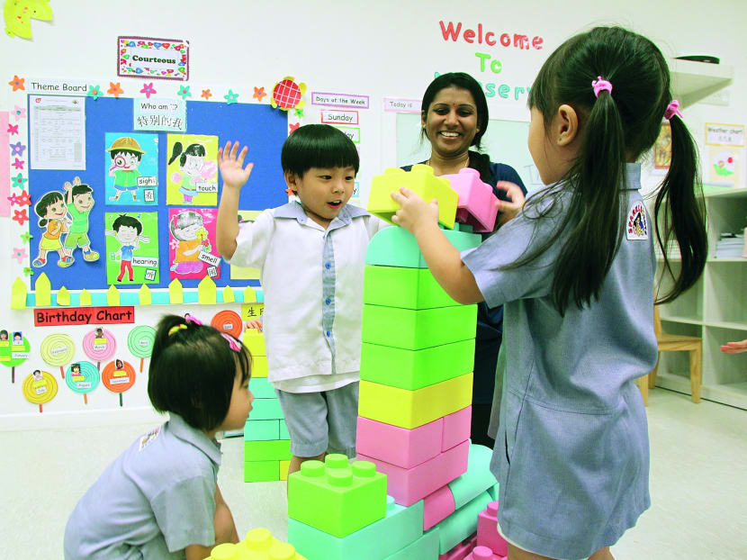 A teacher and kids at play at PCF Sparkletots at Punggol West, Jan 2 2014. TODAY file photo