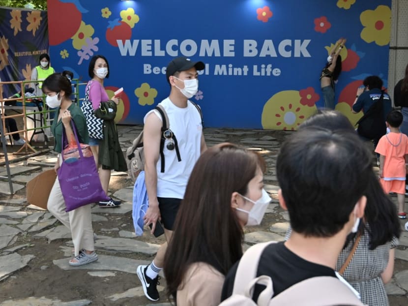 Visitors enter a music festival at Olympic park in Seoul on June 26, 2021.
