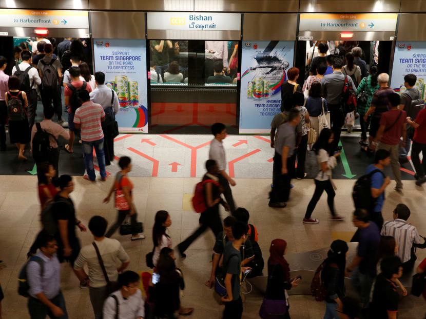 People get on board an SMRT train during morning rush hour in Singapore on  July 19, 2016. Photo: Reuters