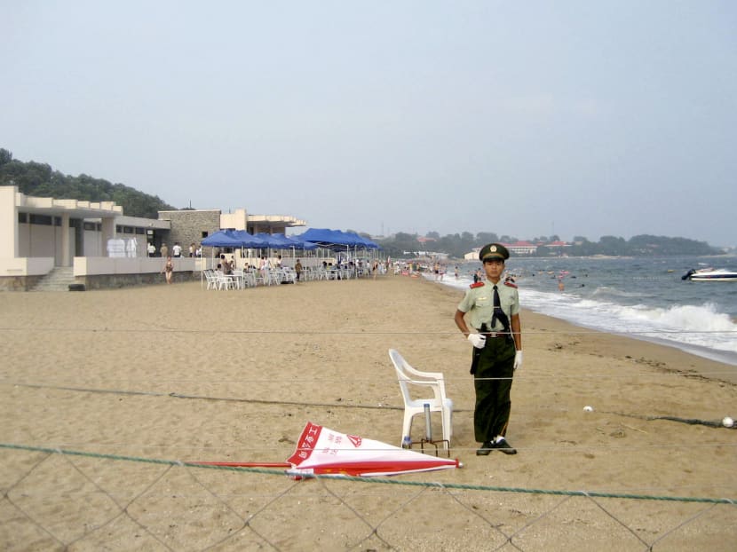 A soldier stands guard at a private beach reserved for government officials in the resort of Beidaihe, north China's Hebei province, August 11, 2007. Every year the country's top politicians come to the resort to hash out leadership changes and policy direction in their secluded, well-guarded villas and beaches. Photo: Reuters