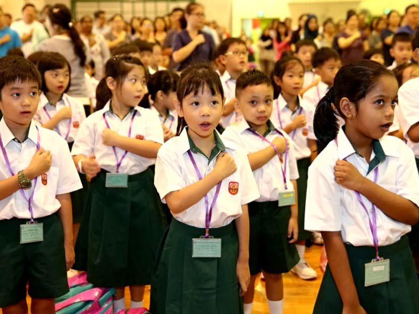 Primary 1 students reciting the pledge for the first time at Princess Elizabeth Primary School. Photo: Nuria Ling/TODAY