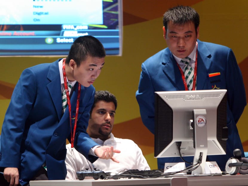 Games officials check the computer of a player prior to an e-sports competition. AFP file photo