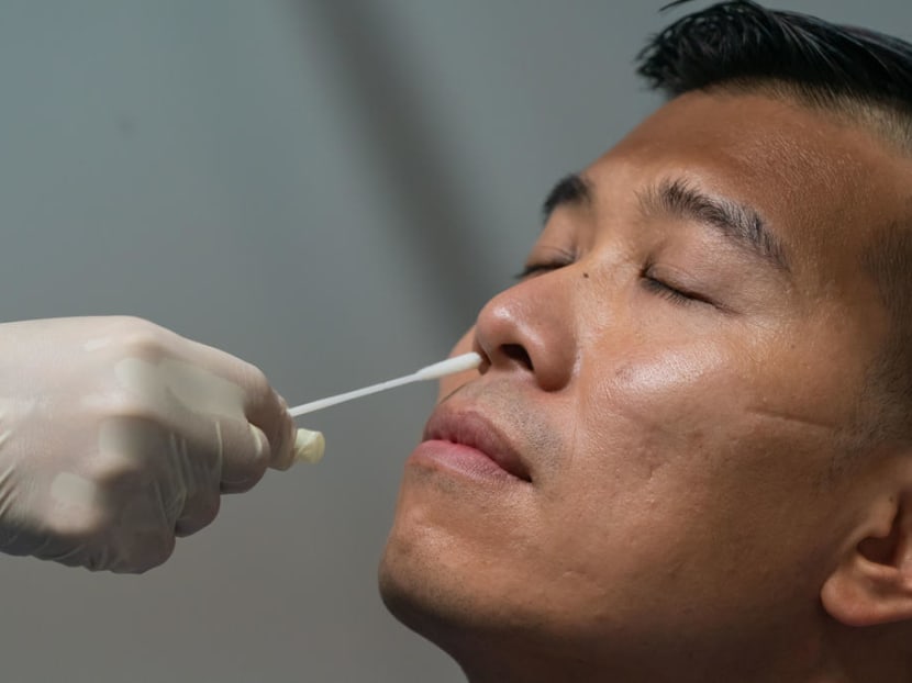 A man undergoing a swab test. From Oct 1, 2021, non-vaccinated workers from selected sectors will be required to undergo regular testing to pick up possible infections early, so that they can be treated early, the Ministry of Health said.