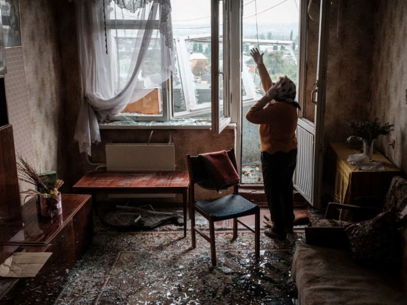 Ms lyubov Prokofjevna, 85, speaks on the phone in her damaged appartment at a residential building hit by a missile in Kharkiv on Sept 21, 2022, amid the Russian invasion of Ukraine.