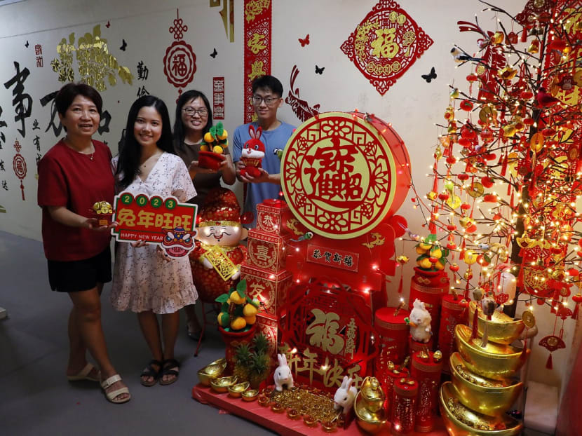 (L-R) Neighbours Madam Kim Yap, Ms Jasmine Ng, Ms May Siow and Mr Ong Zhen Kuang pose on Jan 16, 2023 with the Chinese New Year decorations they worked on together to put up along a section of corridor on the eighth floor of Blk 851, Woodlands Street 83. 