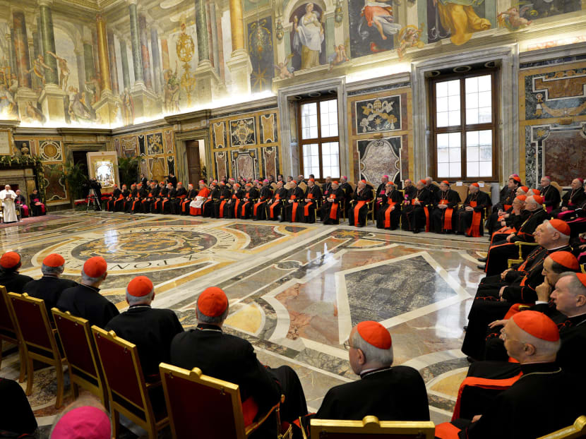 Pope Francis (background left_ delivers his message during his meeting with Cardinals and Bishops of the Vatican Curia on the occasion of the exchange of Christmas greetings in the Clementine hall at Vatican, Dec  22, 2014. Photo: AP