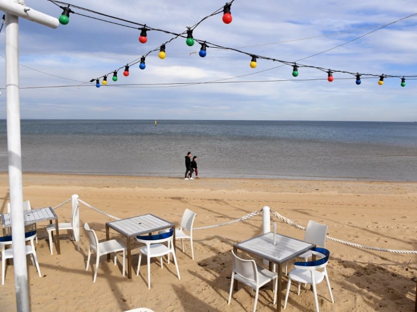 People walk past a closed cafe on Melbourne's St Kilda Beach foreshore on June 1, 2021 on the fifth day of a seven-day lockdown as the city battles with an outbreak of the Indian variant of Covid-19. People walk past a closed cafe on Melbourne's St Kilda Beach foreshore on June 1, 2021 on the fifth day of a seven-day lockdown as the city battles with an outbreak of the Indian variant of Covid-19.
