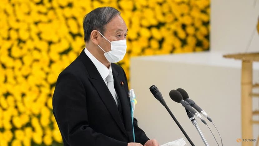 Japan's Suga pledges not to wage war again as ministers visit controversial shrine