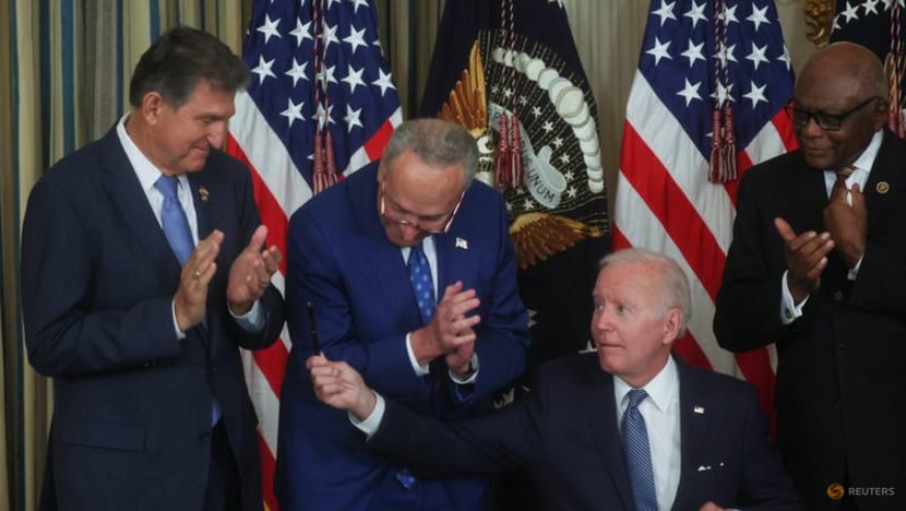 Biden signs inflation act, hands pen to Manchin 