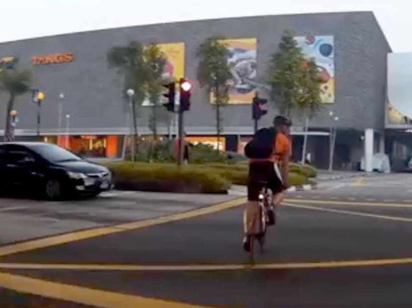 A screen grab of an in-car video of the cyclist who was stopping traffic along Keppel Road.