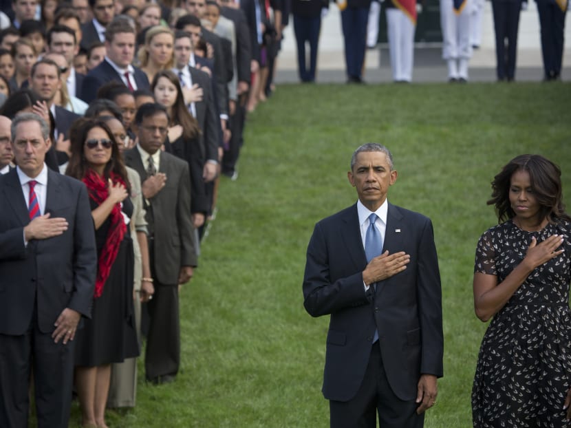 File photo of President Barack Obama and first lady Michelle Obama observing the anniversary of the Sept 11 attacks during a ceremony at the White House in Washington, Sept 11, 2014. Photo: The New York Times