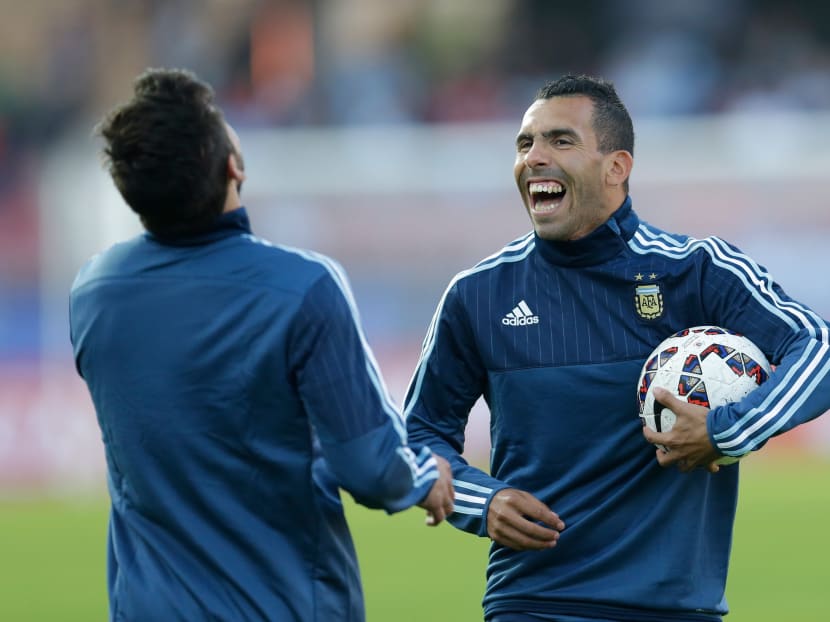 Argentina's Carlos Tevez shares a laugh with teammate Ezequiel Lavezzi. AP file photo