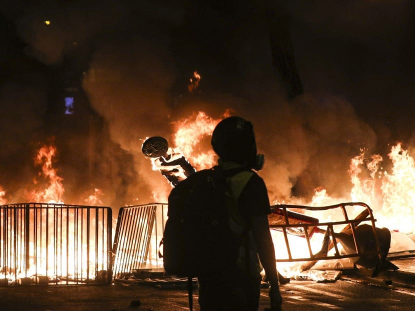 Fires blaze on the streets of Hong Kong on Saturday. Fires blaze on the streets of Hong Kong on Saturday.