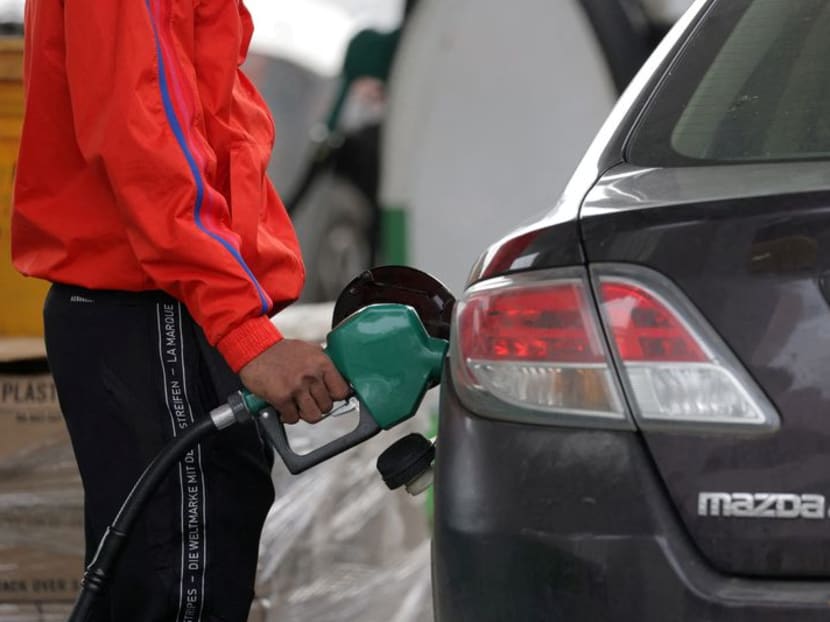 FILE PHOTO: A person uses a petrol pump at a gas station as fuel prices surged in Manhattan, New York City, U.S., March 7, 2022. REUTERS/Andrew Kelly/ FILE PHOTO: A person uses a petrol pump at a gas station as fuel prices surged in Manhattan, New York City, U.S., March 7, 2022. REUTERS/Andrew Kelly/