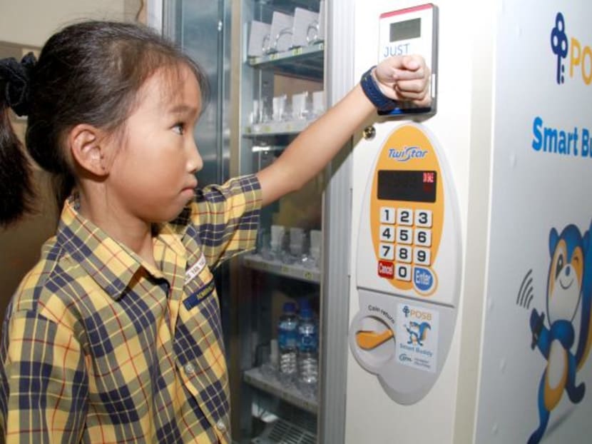 A primary school student using the smart buddy watch to make payment. TODAY file photo