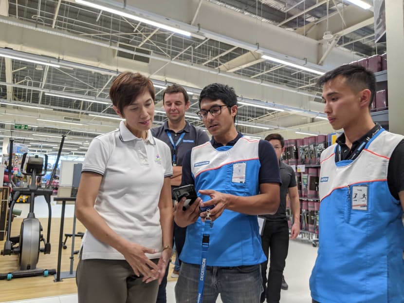 Manpower Minister Josephine Teo speaking to Decathlon staff at its outlet in Kallang on Monday (Dec 9).