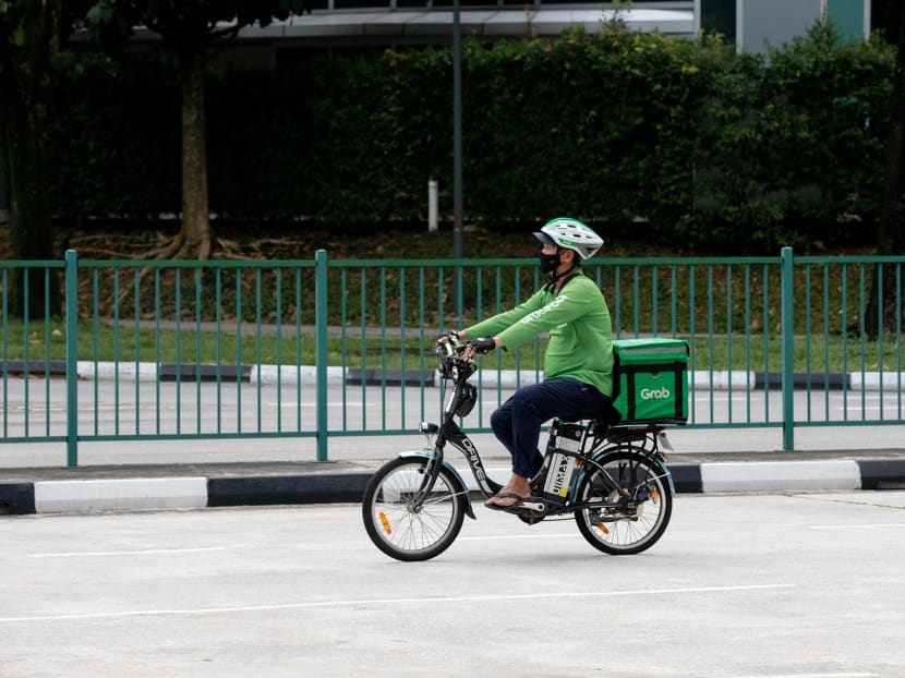 A food delivery rider is seen on the road near the Jem shopping mall in Jurong East on May 17, 2021. One popular form of freelance work among Singaporeans is delivery riders who work for food delivery platforms such as Grab, Foodpanda or Deliveroo. A food delivery rider is seen on the road near the Jem shopping mall in Jurong East on May 17, 2021. One popular form of freelance work among Singaporeans is delivery riders who work for food delivery platforms such as Grab, Foodpanda or Deliveroo.