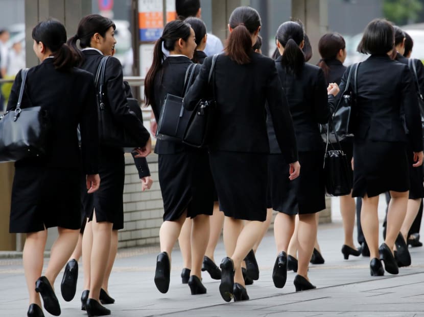 Female office workers make their way at a business district in Tokyo, Japan. Female office workers make their way at a business district in Tokyo, Japan.