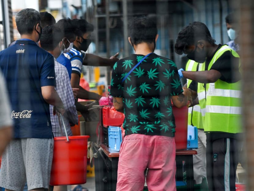Residents queueing for food at a migrant workers dormitory that was placed under government restriction to curb the spread of Covid-19 in Singapore on April 19, 2020. Residents queueing for food at a migrant workers dormitory that was placed under government restriction to curb the spread of Covid-19 in Singapore on April 19, 2020.
