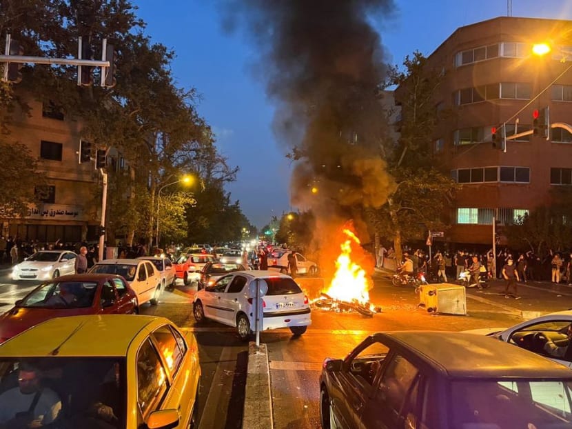 A police motorcycle burns during a protest over the death of Mahsa Amini, a woman who died after being arrested by the Islamic republic's "morality police", in Tehran, Iran on Sept 19, 2022. A police motorcycle burns during a protest over the death of Mahsa Amini, a woman who died after being arrested by the Islamic republic's "morality police", in Tehran, Iran on Sept 19, 2022.