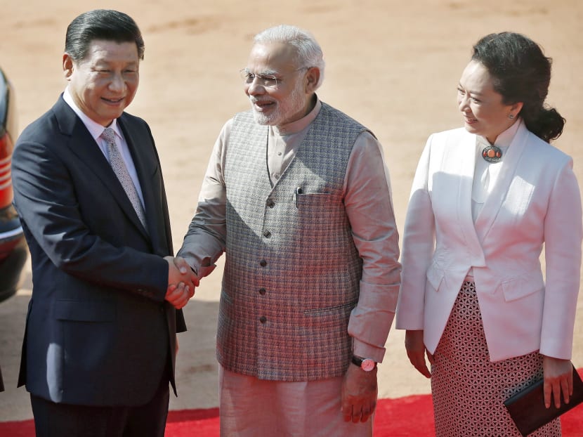 Mr Modi with Mr Xi and his wife, Ms Peng Liyuan, at the forecourt of the Rashtrapati Bhavan palace in New Delhi yesterday. The Indian Prime Minister called for an early border settlement with China. Photo: REUTERS