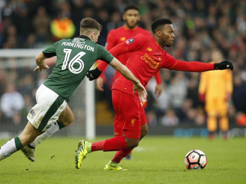 Liverpool's Daniel Sturridge (in red) in action with Plymouth Argyle's Ben Purrington. Photo: Reuters