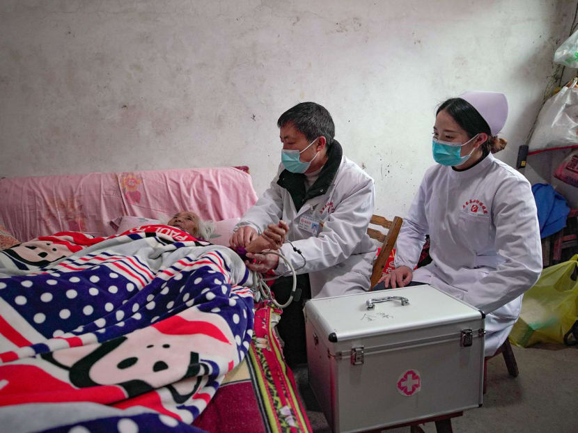 A resident (left) receiving a health check in Danzhai county.
