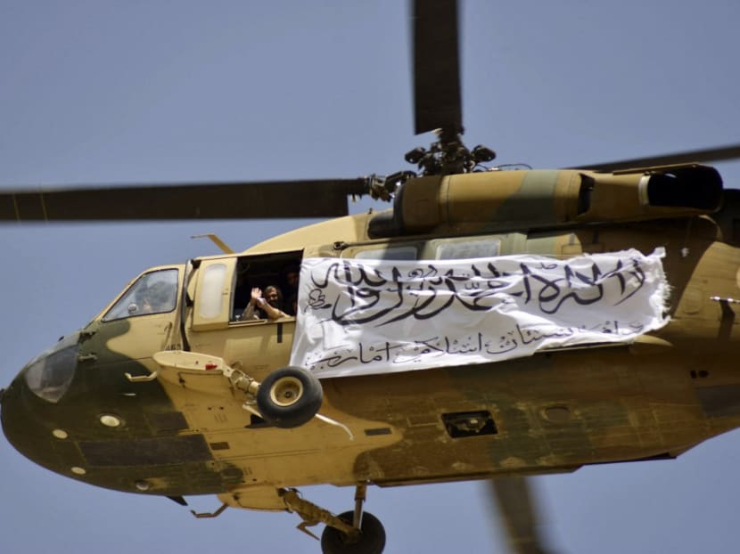 A helicopter displaying a Taliban flag fly above of supporters gathered to celebrate the US withdrawal of all its troops out of Afghanistan, in Kandahar on Sept 1, 2021 following the Taliban’s military takeover of the country.