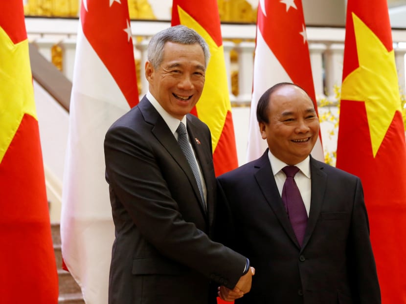 Prime Minister Lee Hsien Loong (left) being welcomed by Vietnam's Prime Minister Nguyen Xuan Phuc in Hanoi, Vietnam. Photo: Reuters