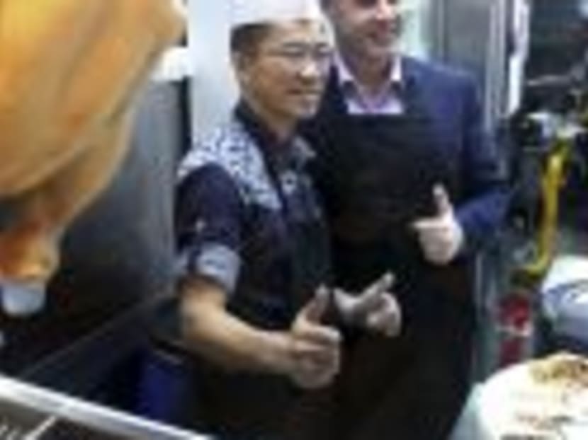 Jew Kit Hainanese Chicken Rice founder Teo Jew Kit (left) and Kaplan’s director of Curriculum and Learning Design Wayne Marriot at the Killiney Road outlet yesterday. Photo: Geneieve Teo