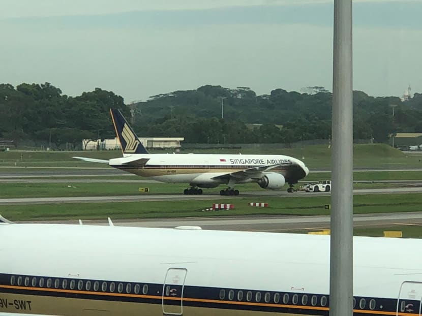 A tow tug caught fire as it was towing a Singapore Airlines Boeing 777-200 to a departure gate at Changi Airport. Photos: Social media