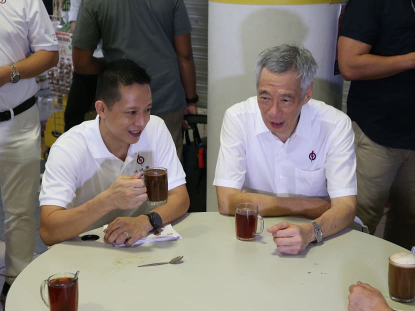 Mr Lee Hsien Loong (right) and Mr Yip Hon Weng (left) did not address the media, but sat down together to chat about the new candidate’s campaign so far, talking over coffee and tea served by one of the stalls.