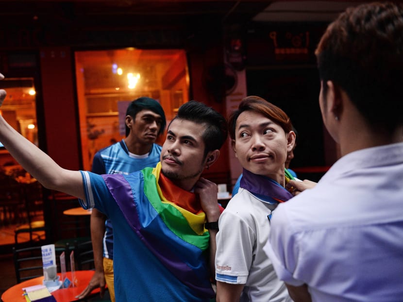 Members of the LGBT community in Thailand take photos as they gather in Bangkok on June 18, 2016 to take part in a vigil for victims of the worst mass shooting in modern US history in Orlando, Florida. Photo: AFP