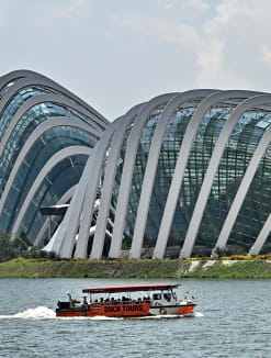 An amphibious vehicle carrying tourists pass the glass dome of the Gardens by the Bay in Singapore.