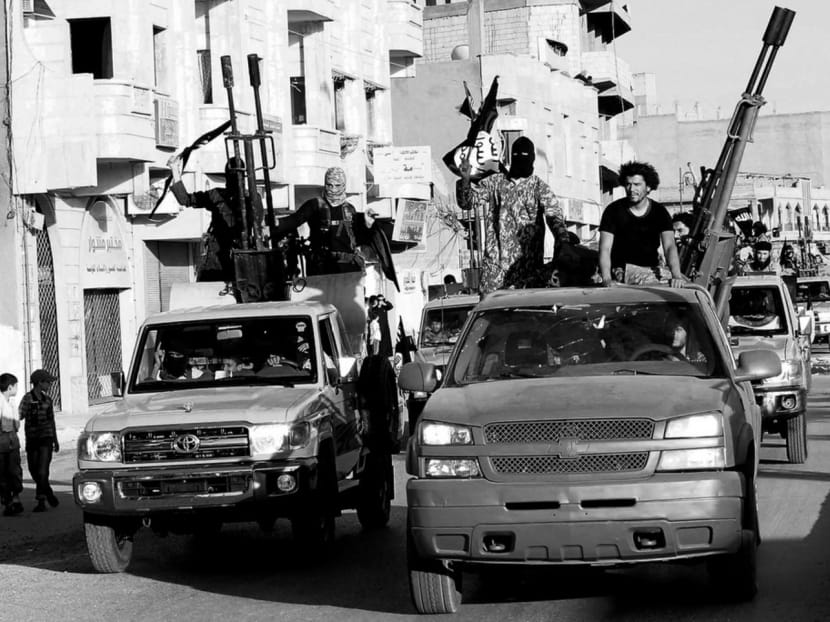Islamist fighters celebrating in Raqqa, Syria on June 30, 2014 after IS captured territory in neighbouring Iraq. PHOTO: Reuters