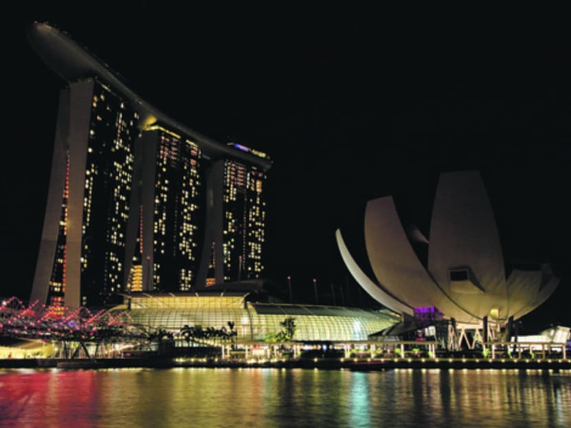 The Marina Bay Sands hotel and ArtScience Museum (R) is seen before Earth Hour in Singapore March 23, 2013.