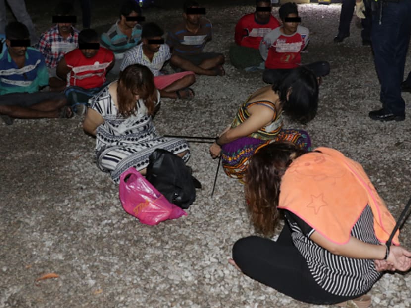 The 13 suspects arrested at the Kaki Bukit forested area on Wednesday night (April 19). Photo: Singapore Police Force