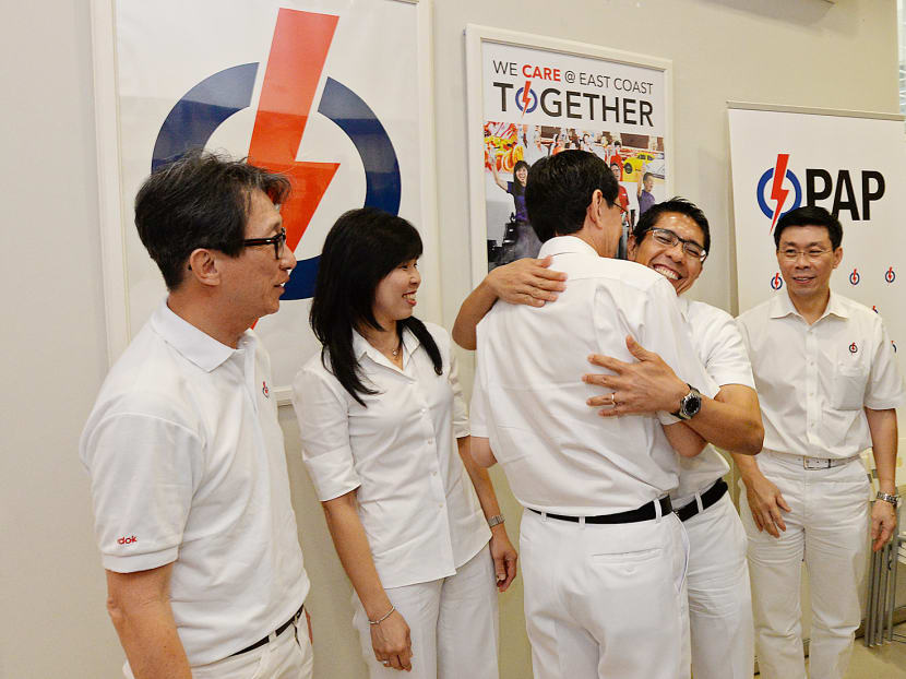 Dr Maliki Osman (second from right) giving Mr Raymond Lim (centre) a hug as members of the current East Coast GRCteam  bid farewell to Mr Lim after announcing his replacement for Fengshan SMC. Photo: Robin Choo