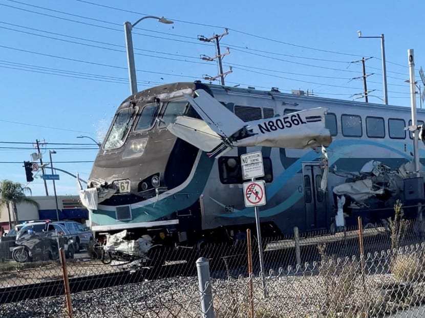 A train hits an aircraft that crashed on railway tracks in Los Angeles, California, on January 9, 2022 in this screen grab from a social media video. A train hits an aircraft that crashed on railway tracks in Los Angeles, California, on January 9, 2022 in this screen grab from a social media video.
