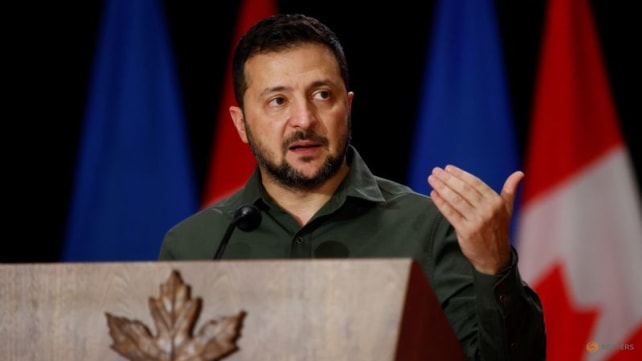 Ukraine's Zelenskyy stops over in Poland to award two volunteers