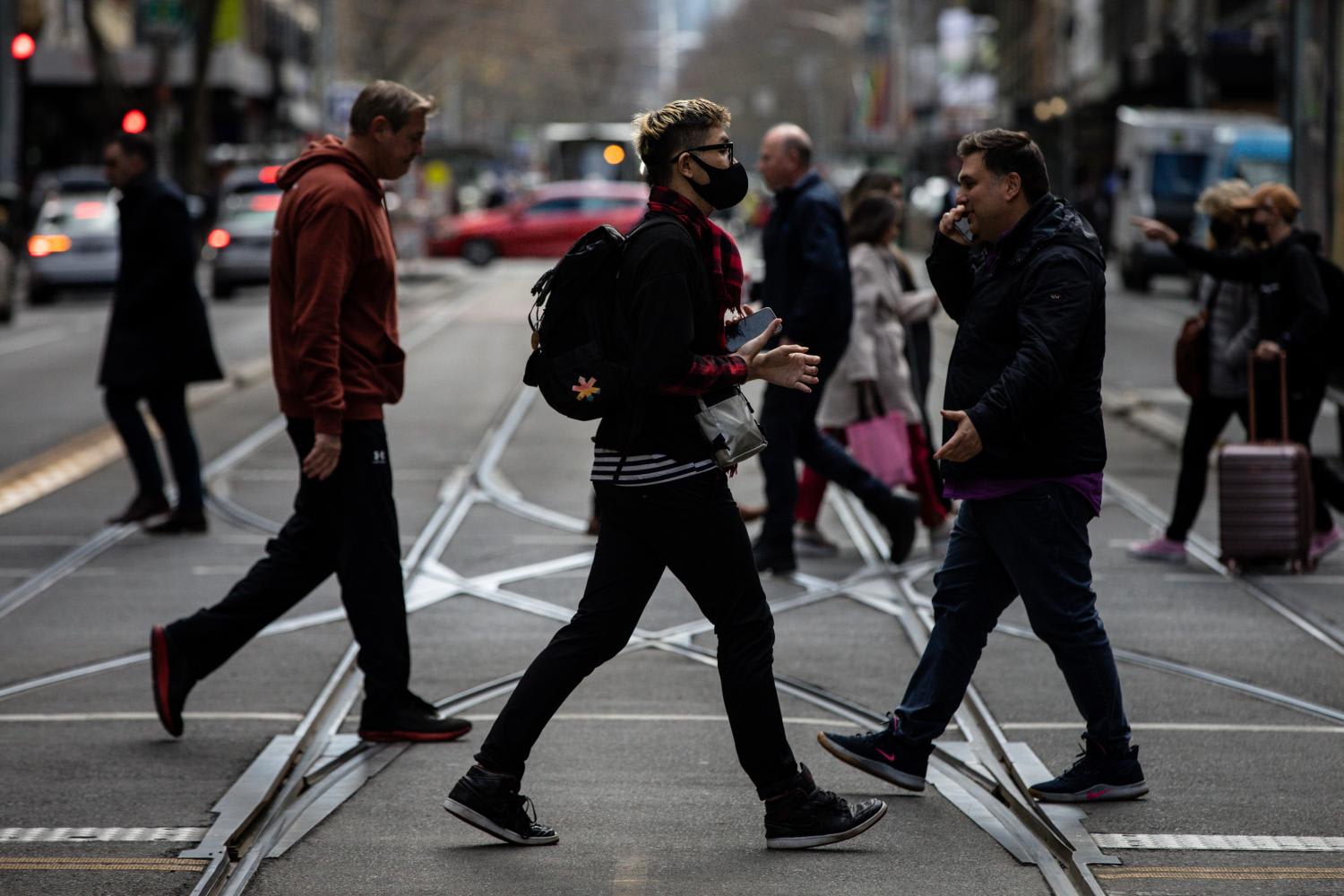 People are seen wearing a face mask, in Melbourne, Tuesday, July 19, 2022. People are seen wearing a face mask, in Melbourne, Tuesday, July 19, 2022.