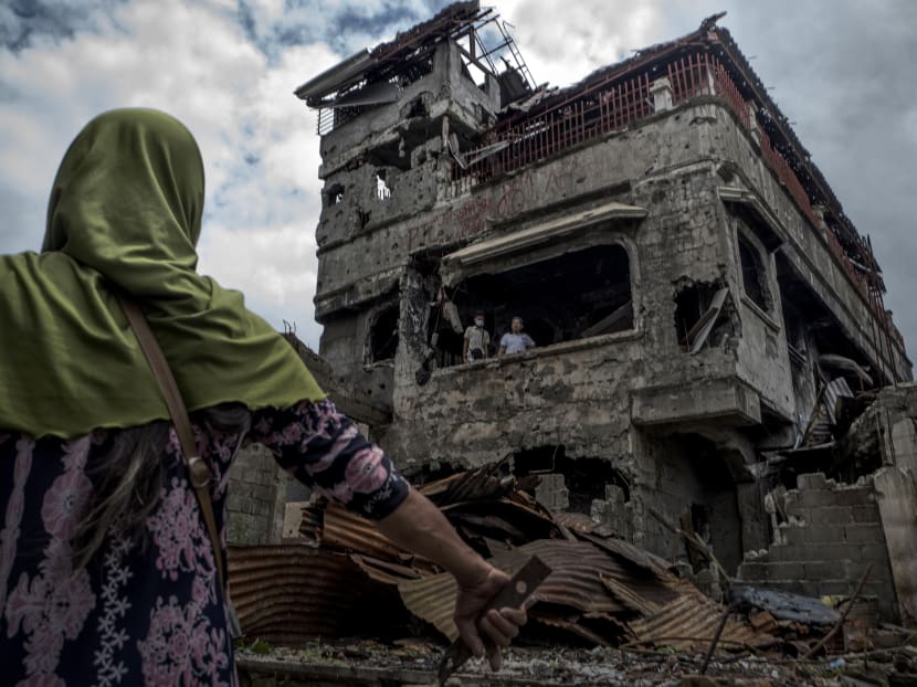 Residents examining the wreckage of their home in Marawi, in the southern Philippines. The author says the siege of Marawi underscored the fact that South-east Asia was unprepared for the current and emerging wave of terrorism and demonstrated the need for new security architecture for the region.