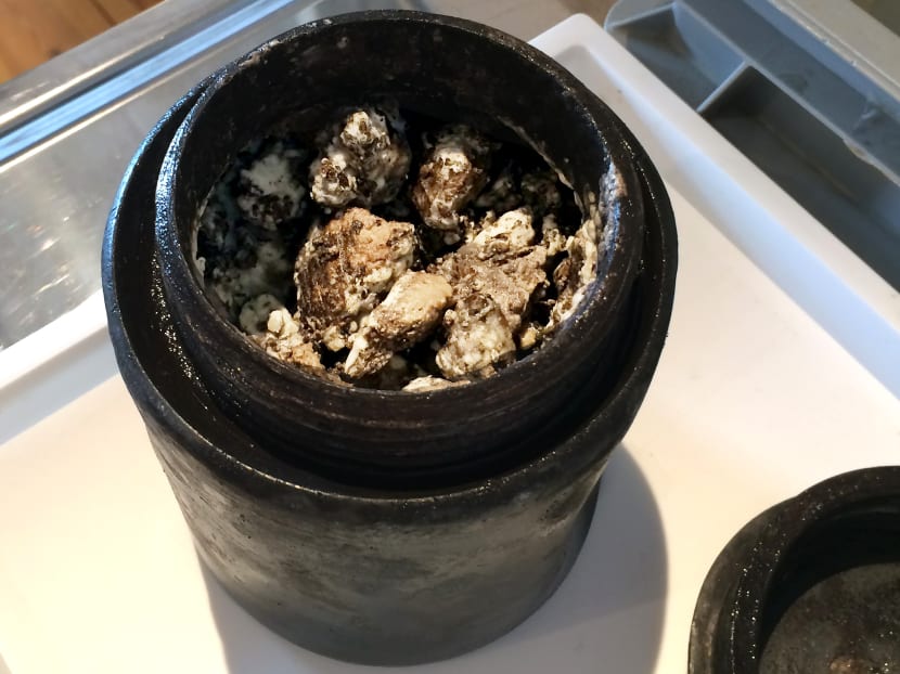 A clay pot with cheese at the Kalmar Museum in southern Sweden. Divers exploring the historic royal shipwreck Kronan off the south-east coast of Sweden have discovered 340-year-old cheese buried in the sea bed below the wreckage. Photo: AFP