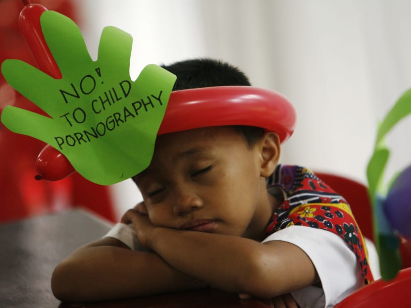 A boy with an anti-child pornography message. Malaysia now holds the dubious distinction of being the No. 1 consumer of child pornography in South-east Asia. Photo: Reuters